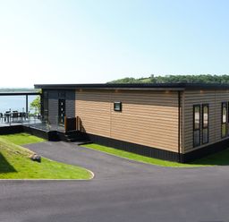 A building with a deck and seating area at Wilde Spa (Pet) Carmarthen