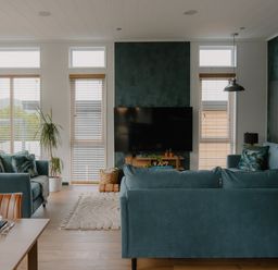 A living room with sofas and a television at Wilde Spa (Pet) in Carmarthen