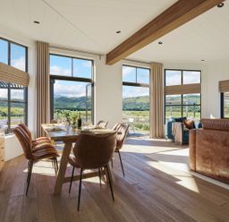 A dining room with a table and chairs at Wansfell (Pet) in Penrith