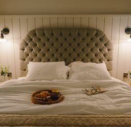A bedroom with a bed and breakfast tray at Wansfell (Pet) Penrith