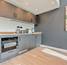 A kitchen with cabinets and utensils at Arvor Wetroom Studio 1.0
