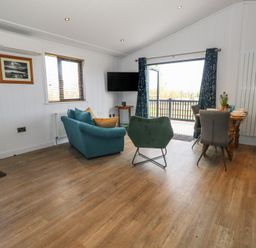 A living room with a sofa and table at Grass Roots