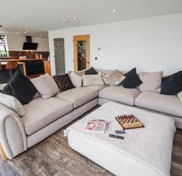 A living room with a sofa and coffee table at The Joiners Cottage in Birling near Warkworth