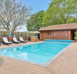 An outdoor area with a swimming pool and lounge chairs at Oldfields