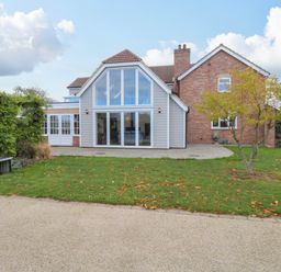 A house with large windows and a garden at Oldfields in Bury St Edmunds
