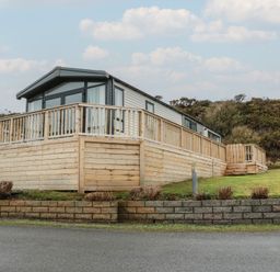 A holiday caravan with decking and garden space at Willow's Way in Stranraer