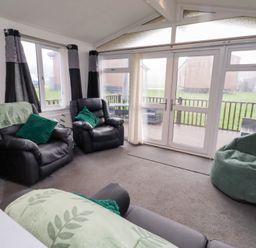 A living room with sofas and bean bags at Harper's Hideaway near Felmoor Holiday Park near Felton