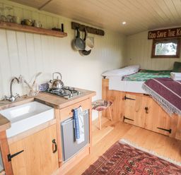 A kitchen area with a sink and stovetop at Honeysuckle Hut, Potto Grange Farm Northallerton