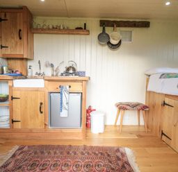 A kitchen with storage and appliances at Honeysuckle Hut, Potto Grange Farm, Northallerton