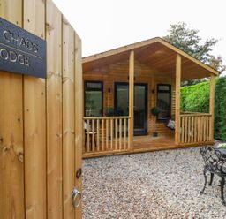 An outdoor area with a lodge and seating at St. Chad's Lodge in Bodmin