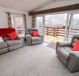 A living room with two armchairs and a sofa at Chloe's Cabin near Felmoor Holiday Park
