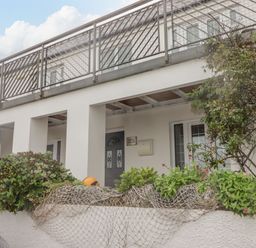 A house with a balcony and plants at Rock House in Narberth