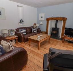 A living room with sofas and a table at Rock House in Narberth