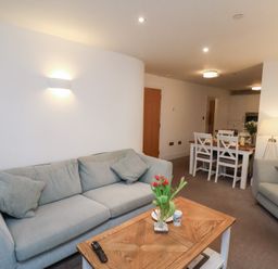 A living room with a sofa and coffee table at One Union Mill - garden apartment Whitby