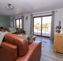 A living room with a sofa and coffee table at Star Carr Lakes