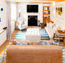 A living room with a sofa, coffee table, and television at Gardeners Cottage in Chipping Norton