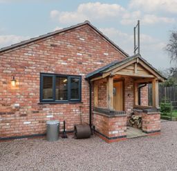 A brick exterior with an entryway at Otter's Rest in Droitwich