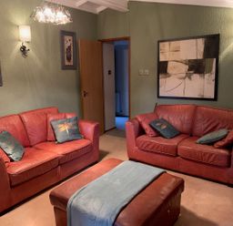 A living room with two sofas and wall art at The Hermitage in Penrith