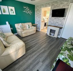 A living room with sofas and a television at Chalet 58 California, Norfolk