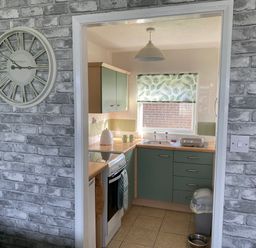 A kitchen with cabinets and a sink at Chalet 58 California, Norfolk