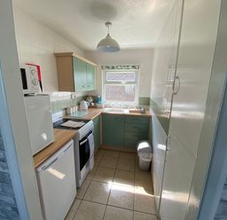 A kitchen with appliances and cabinets at Chalet 58, California, Norfolk