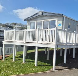 A mobile home with a deck and steps at 21 Gorse Hill in Exmouth