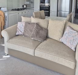 A living room with a sofa and kitchen in view at 21 Gorse Hill, Exmouth
