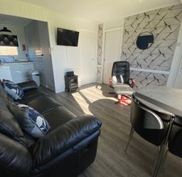 A living room with a sofa and chairs at Chalet 333 in California, Norfolk
