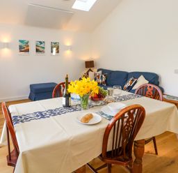 A dining room with a table and chairs at The Pebble in Dorchester