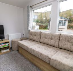 A living room with a sofa and television at Valley 36 in Kingsbridge