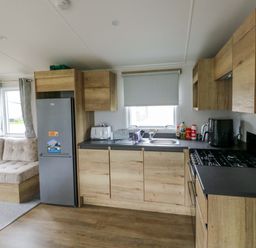 A kitchen with a fridge, stove, and sink at Valley 36 in Kingsbridge