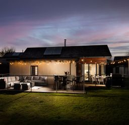 A house with outdoor seating and lights at Summerset Lodge