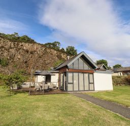 A house with a patio and pathway at Summerset Lodge in Bamburgh