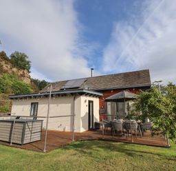 A house with decking and furniture at Summerset Lodge in Bamburgh