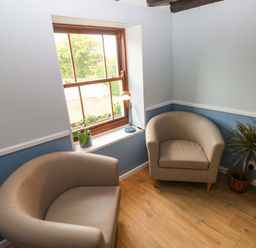 A snug with two armchairs and a lamp at Beacon House in Marloes near Little Haven