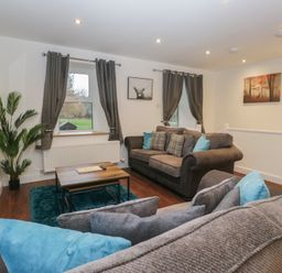 A living room with sofa and coffee table at 6 Hallin Fell in Penrith
