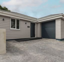 A house with a garage and entrance at Creek Lodge in Chacewater