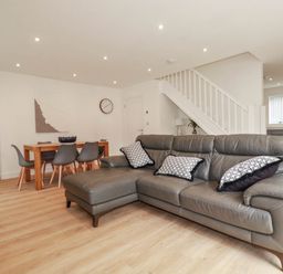 A living room with a sofa and dining table at Creek Lodge in Chacewater