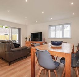 A living room with a sofa and dining table at Creek Lodge in Chacewater