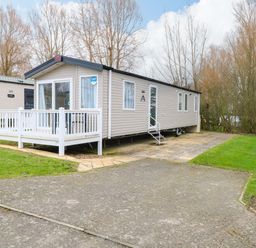 A caravan with decking and steps at Caravan in Great Yarmouth