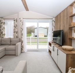 A living room with a sofa and television at Caravan in Great Yarmouth