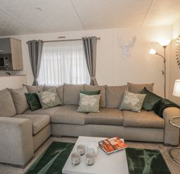 A living room with a sectional sofa and a coffee table at The Ridgeway in New Quay