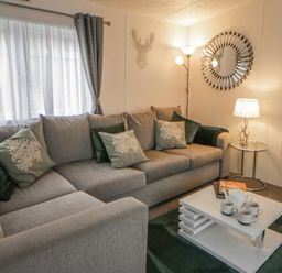 A living room with a sofa and coffee table at The Ridgeway in New Quay