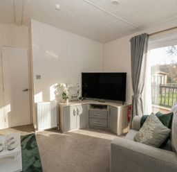 A living room with a television and sofa at The Ridgeway in New Quay