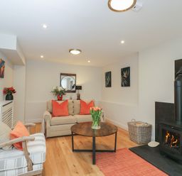 A living room with a coffee table and a fireplace at Paddock View in Stow-On-The-Wold