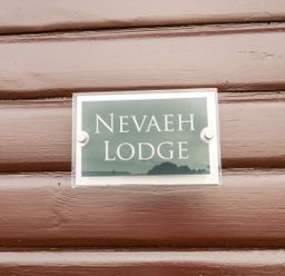 A sign displaying Nevaeh Lodge at Nevaeh Lodge in Longframlington