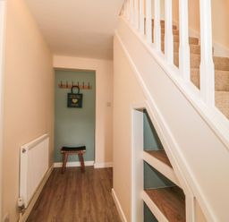 A hallway with staircase and bench at Ammerham Farm Cottage Ammerham near Winsham