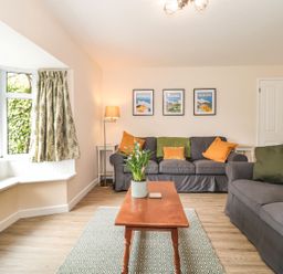 A living room with sofas and a coffee table at Ammerham Farm Cottage in Ammerham near Winsham