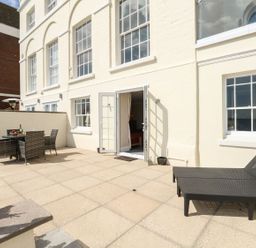 An outdoor area with a table and chairs at Ocean Wave in Greenhill