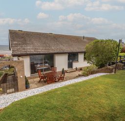 A house with a garden and patio at Tigh-Na-Mara Retreat